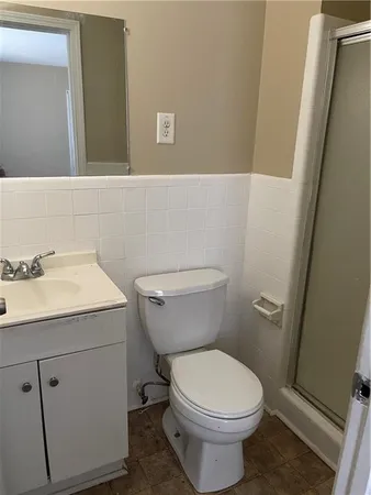 a bathroom with a sink a toilet and a mirror