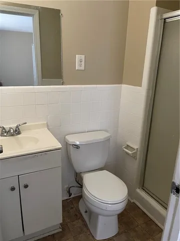 a bathroom with a sink a toilet and a mirror