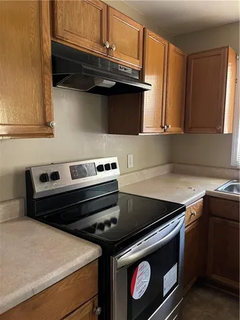 a stove top oven sitting inside of a kitchen