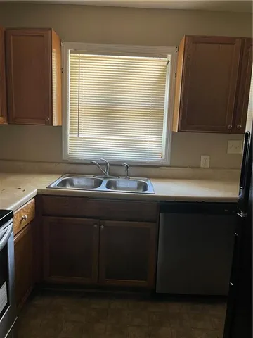 a sink sitting in a bathroom next to a window