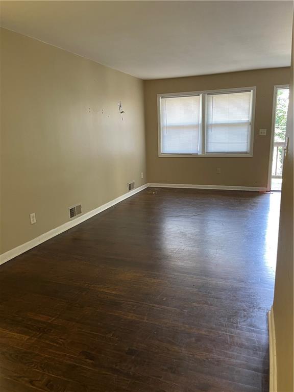 3692 Larkspur Terrace Decatur, GA 30032 - Photo 10 of 20 a view of an empty room with wooden floor and a window