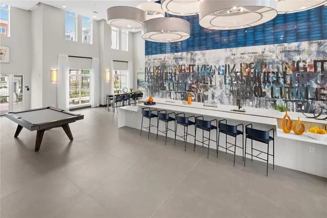 a large living room with couches and a large fish tank