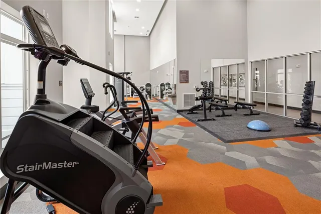 a bed room with furniture and gym equipment