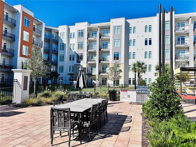a view of a patio with a table and chairs and potted plants
