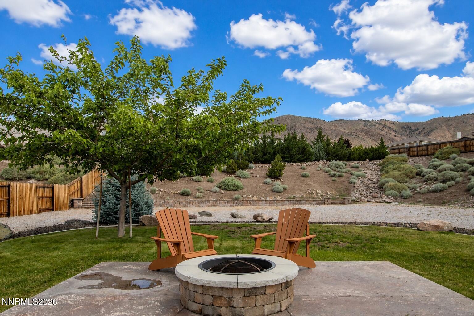 10150 Barrel Racer Drive Reno, NV 89521 - Photo 4 of 64 a view of a chairs and table in the garden