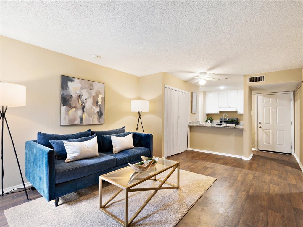 a living room with furniture and kitchen view