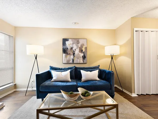a living room with furniture and a lamp