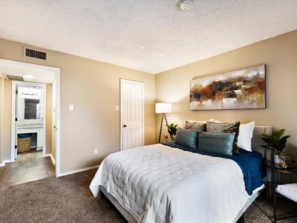 a bedroom with bed and wall painting