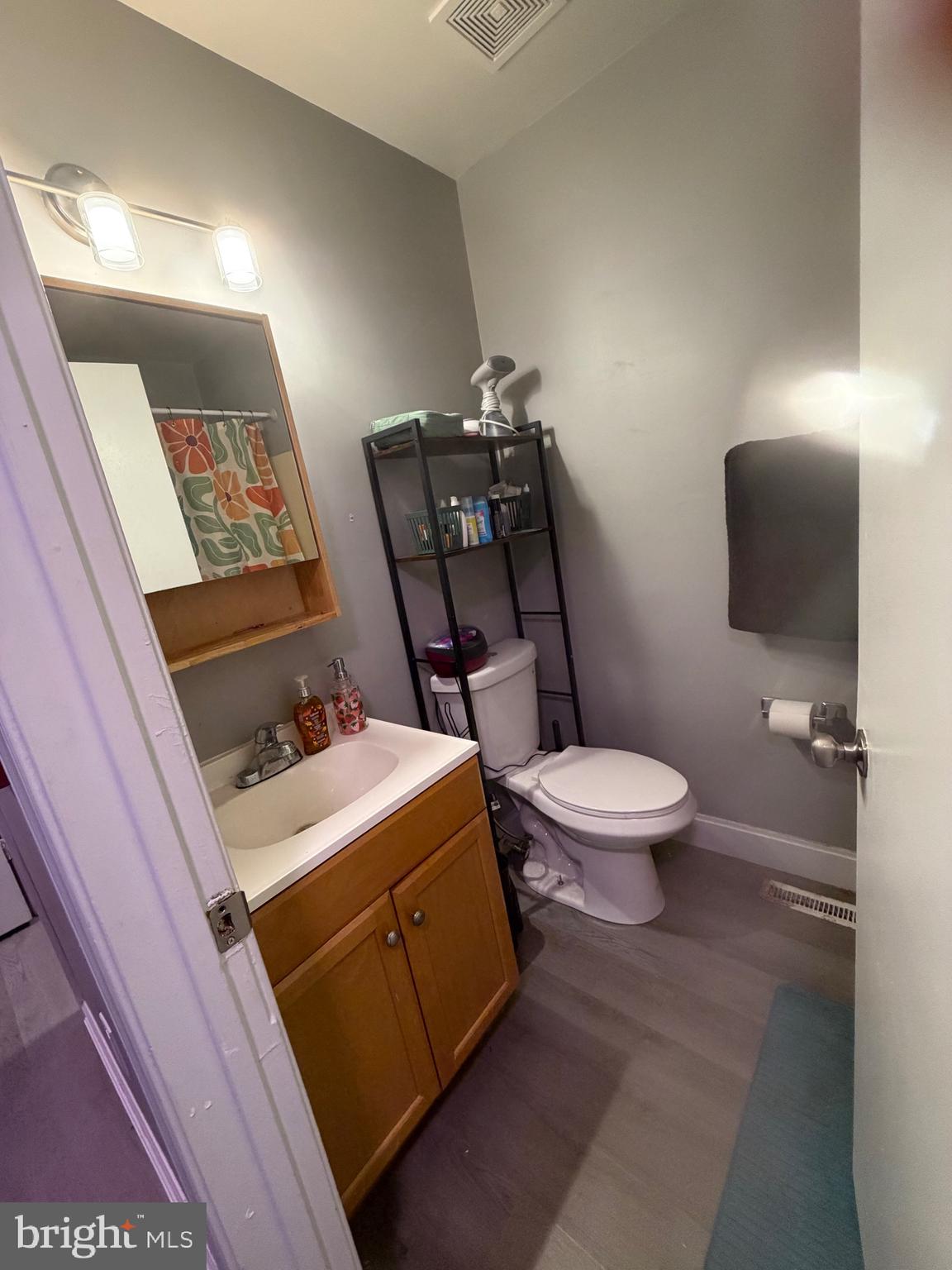 218 Highland Boulevard, Unit 67 New Castle, DE 19720 - Photo 5 of 12 a bathroom with a toilet a sink and vanity