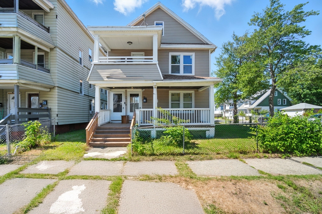 56-58 Phoenix Street Springfield, MA 01104 - Photo 1 of 29 a front view of a house with a yard and outdoor seating
