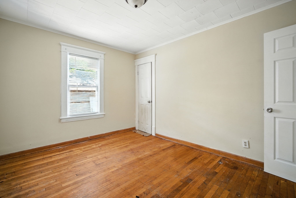 56-58 Phoenix Street Springfield, MA 01104 - Photo 11 of 29 a view of empty room with wooden floor and fan