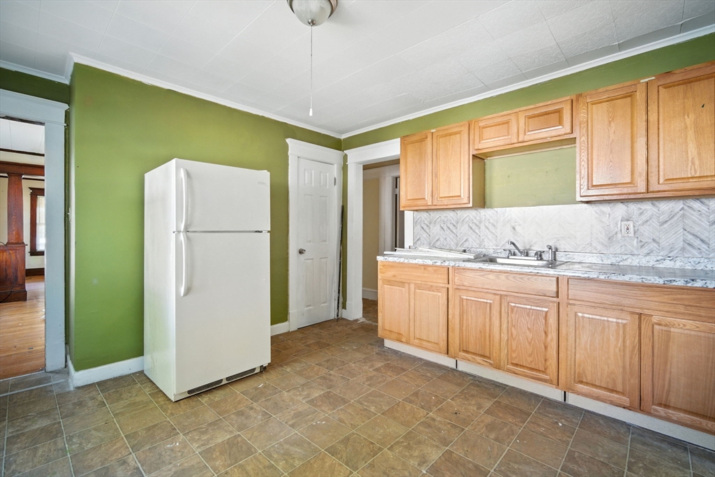 56-58 Phoenix Street Springfield, MA 01104 - Photo 14 of 29 a kitchen with a refrigerator sink and cabinets