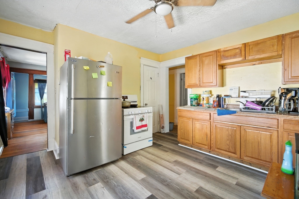 56-58 Phoenix Street Springfield, MA 01104 - Photo 15 of 29 a kitchen with stainless steel appliances a refrigerator and a stove top oven