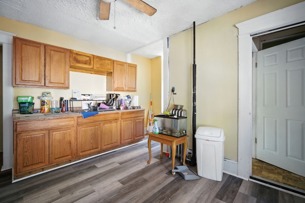 56-58 Phoenix Street Springfield, MA 01104 - Photo 16 of 29 a kitchen with sink cabinets and wooden floor