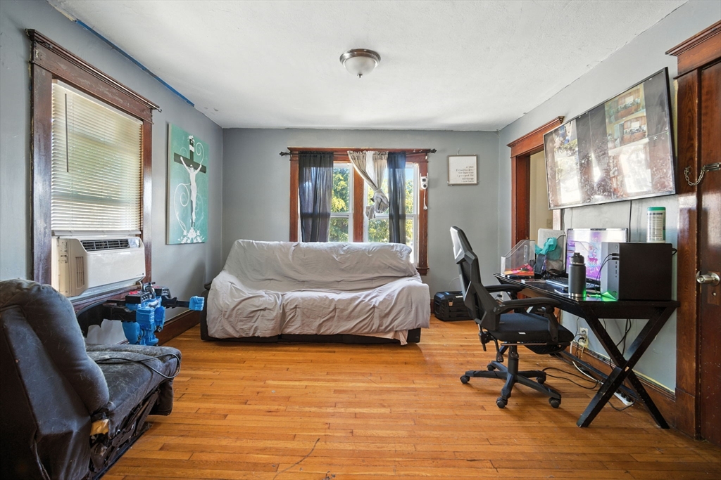 56-58 Phoenix Street Springfield, MA 01104 - Photo 19 of 29 a bedroom with a bed and wooden floor