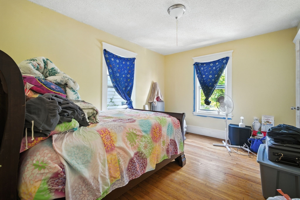 56-58 Phoenix Street Springfield, MA 01104 - Photo 21 of 29 a bed sitting in a bedroom next to a window