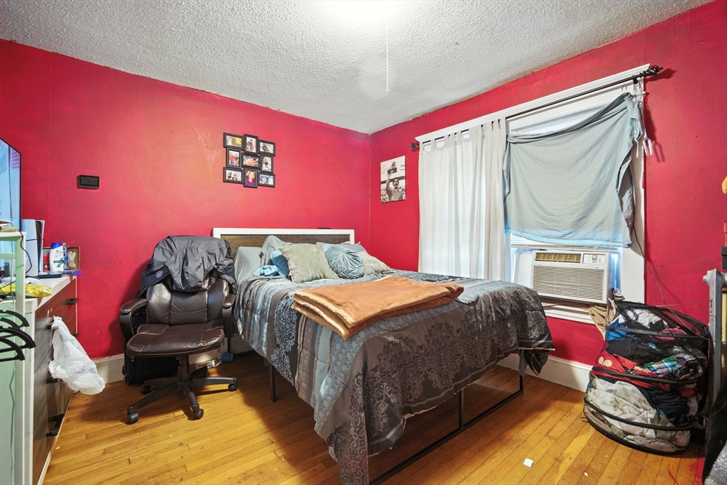 56-58 Phoenix Street Springfield, MA 01104 - Photo 23 of 29 a bedroom with a bed and wooden floor