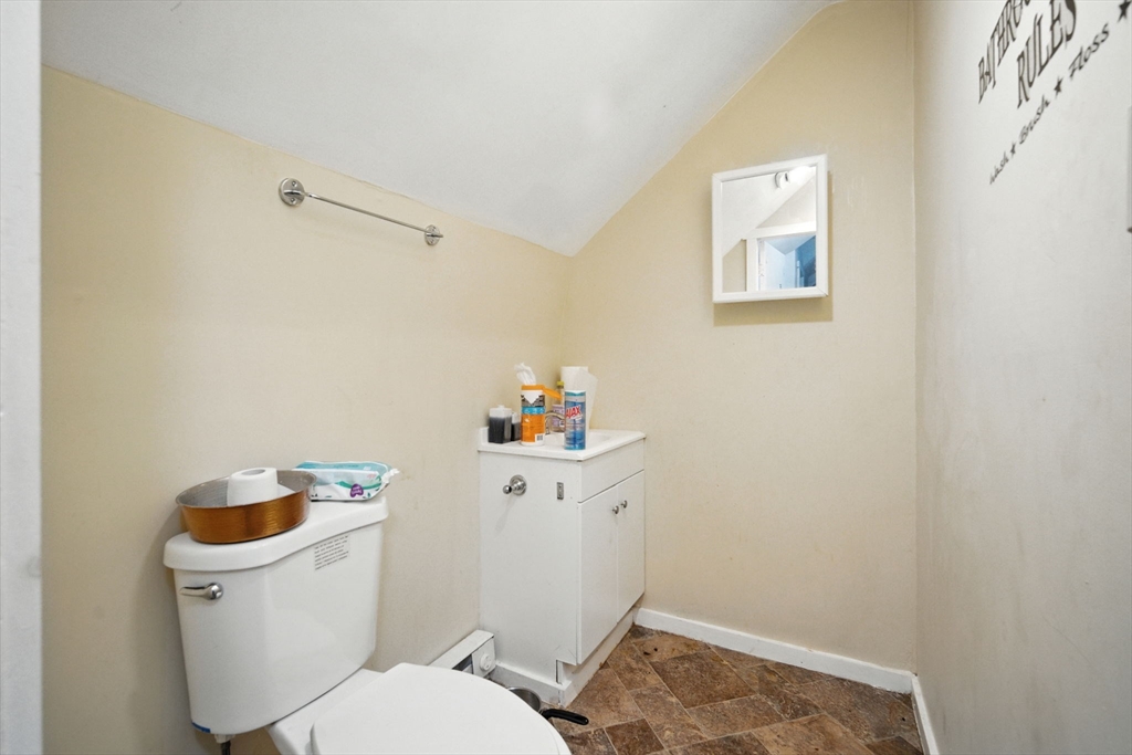 56-58 Phoenix Street Springfield, MA 01104 - Photo 25 of 29 a white toilet sitting next to a bathroom sink and vanity