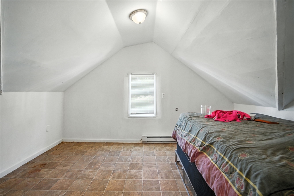 56-58 Phoenix Street Springfield, MA 01104 - Photo 29 of 29 a bed sitting in a bedroom next to a window