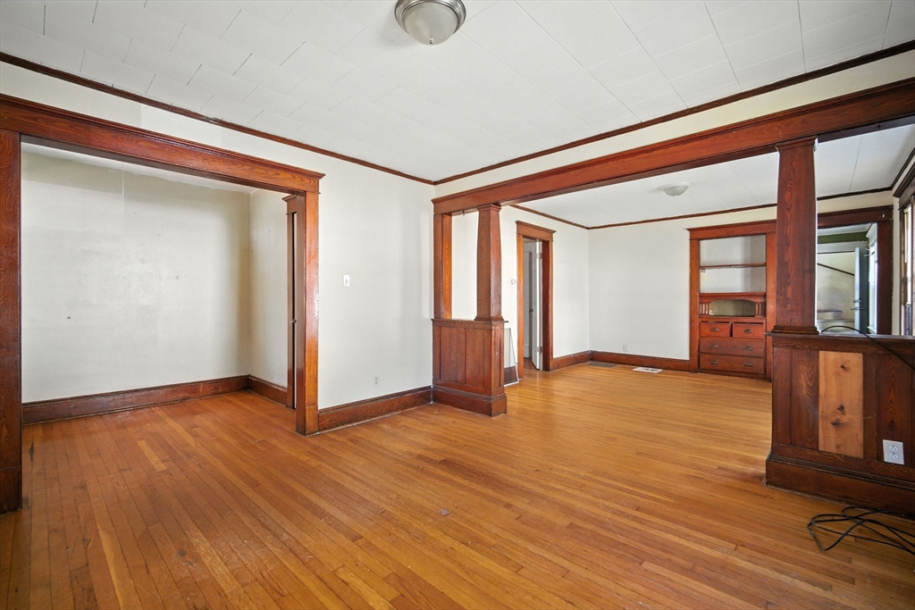 56-58 Phoenix Street Springfield, MA 01104 - Photo 3 of 29 a view of an empty room with window and wooden floor