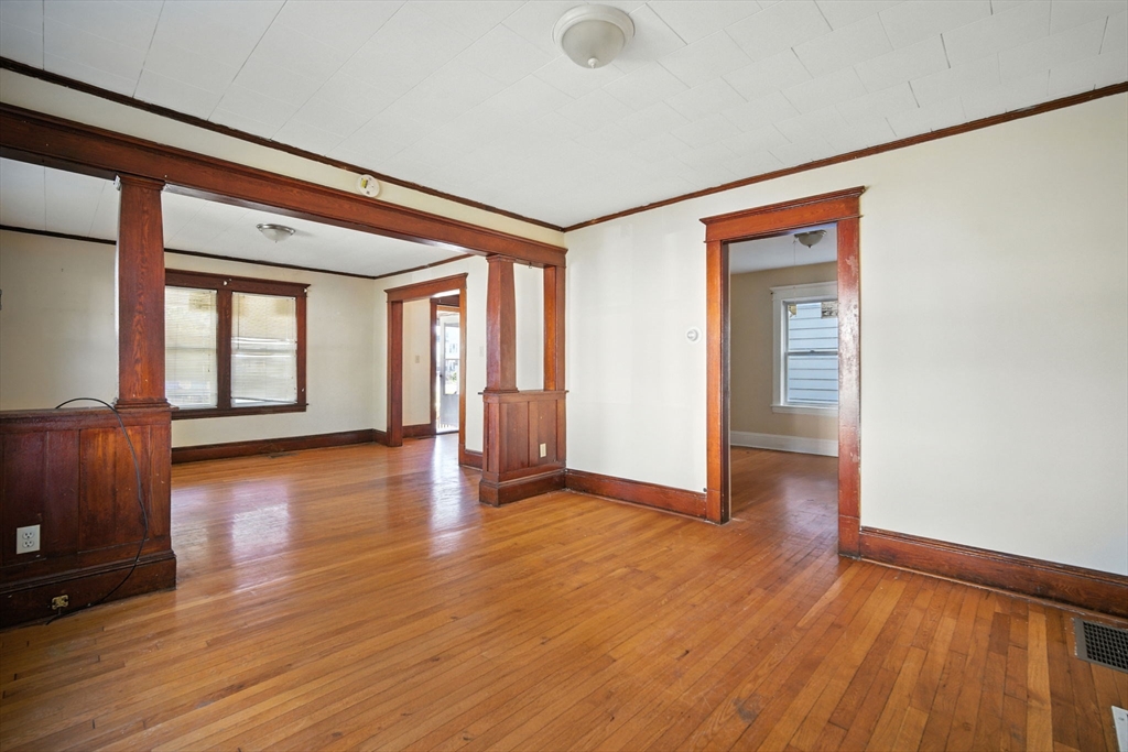 56-58 Phoenix Street Springfield, MA 01104 - Photo 6 of 29 wooden floor in an empty room with a window