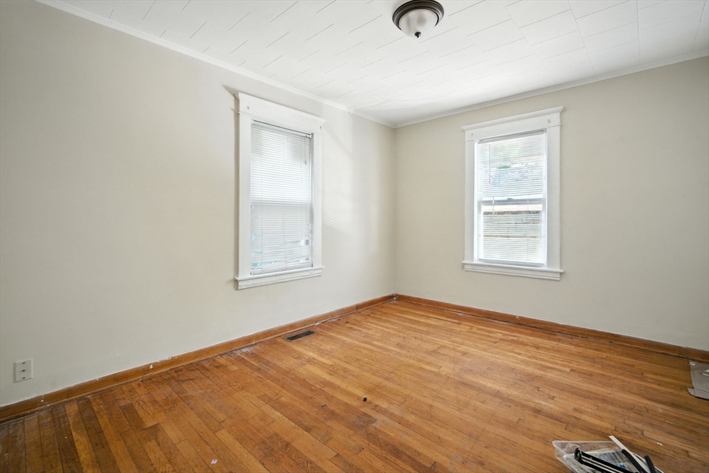 56-58 Phoenix Street Springfield, MA 01104 - Photo 9 of 29 a view of an empty room with wooden floor and a window