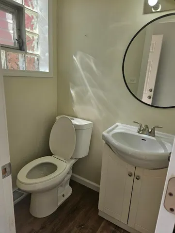 a bathroom with a toilet sink and mirror