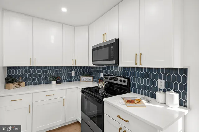 a kitchen with a sink and a stove top oven
