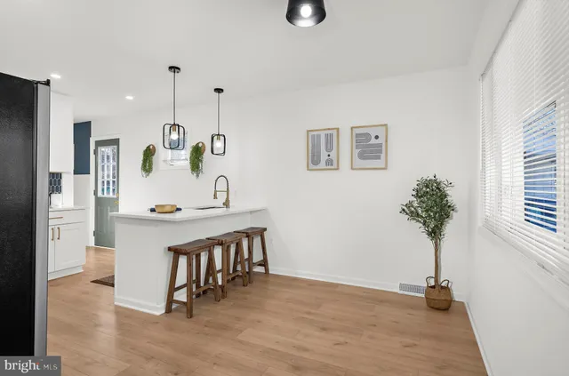 a view of a dining room with furniture and a chandelier