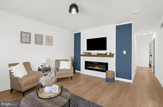 a living room with furniture a fireplace and a flat screen tv