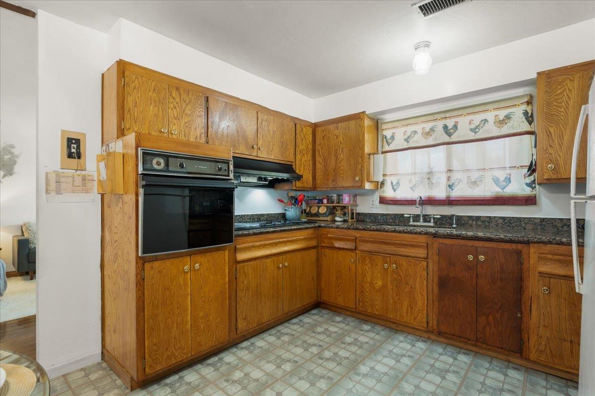 386 Heath Street Milpitas, CA 95035 - Photo 11 of 22 a kitchen with granite countertop a sink and cabinets