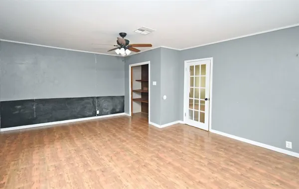 a kitchen with a sink appliances cabinets and a large window