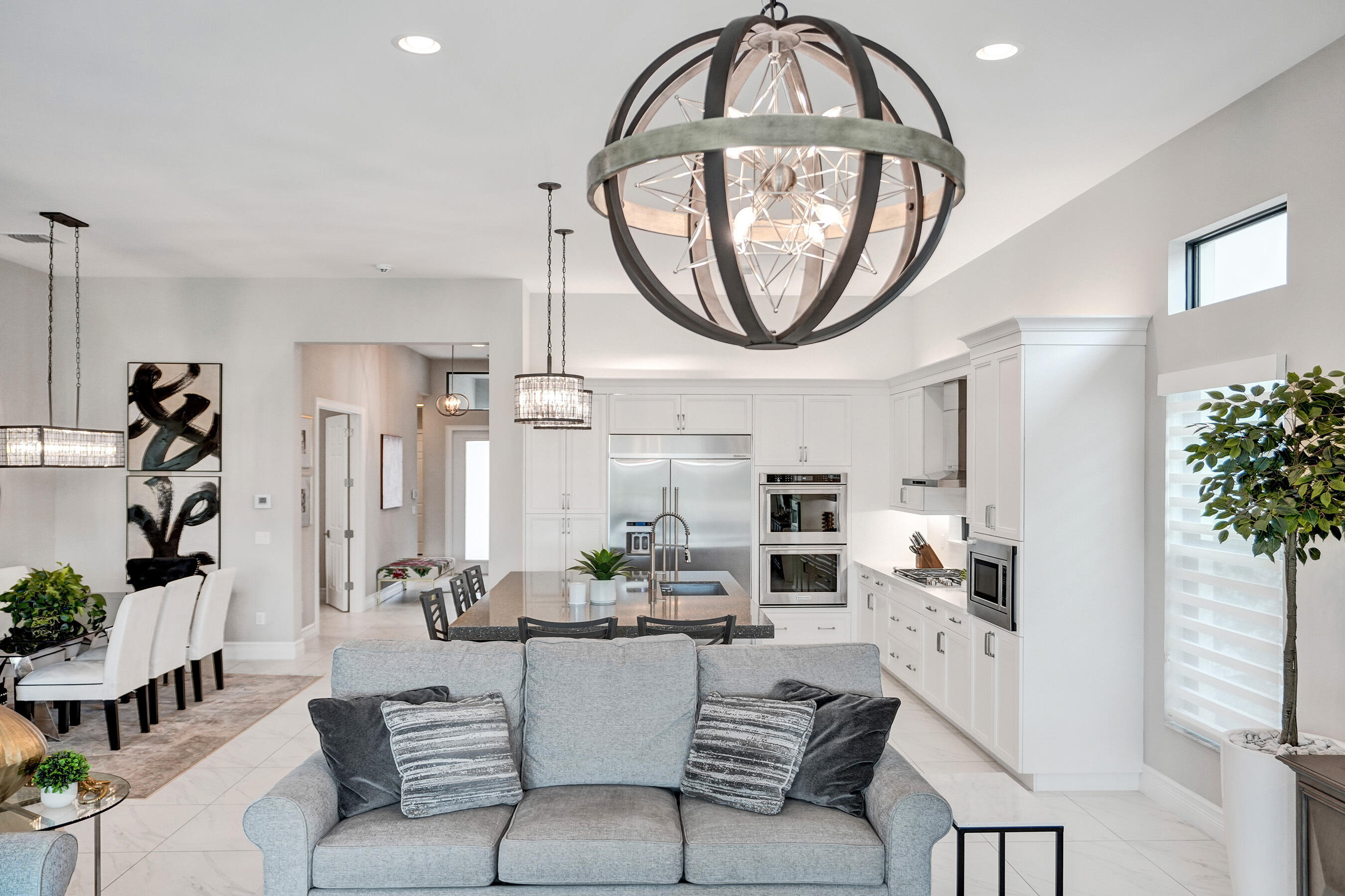 9052 Chauvet Way Boca Raton, FL 33496 - Photo 13 of 59 a living room with furniture a chandelier and a large mirror
