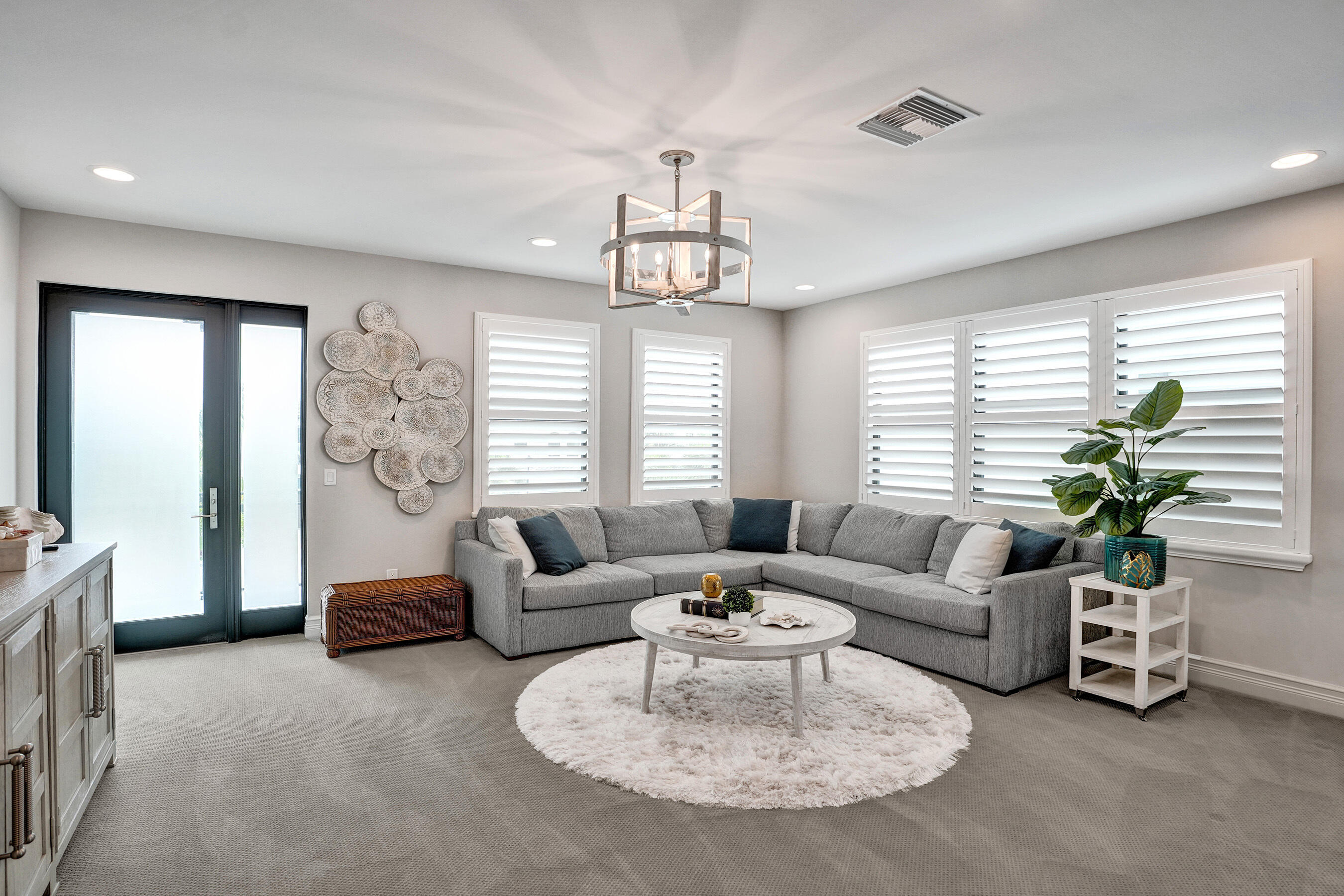 9052 Chauvet Way Boca Raton, FL 33496 - Photo 32 of 59 a living room with furniture chandelier and a large window
