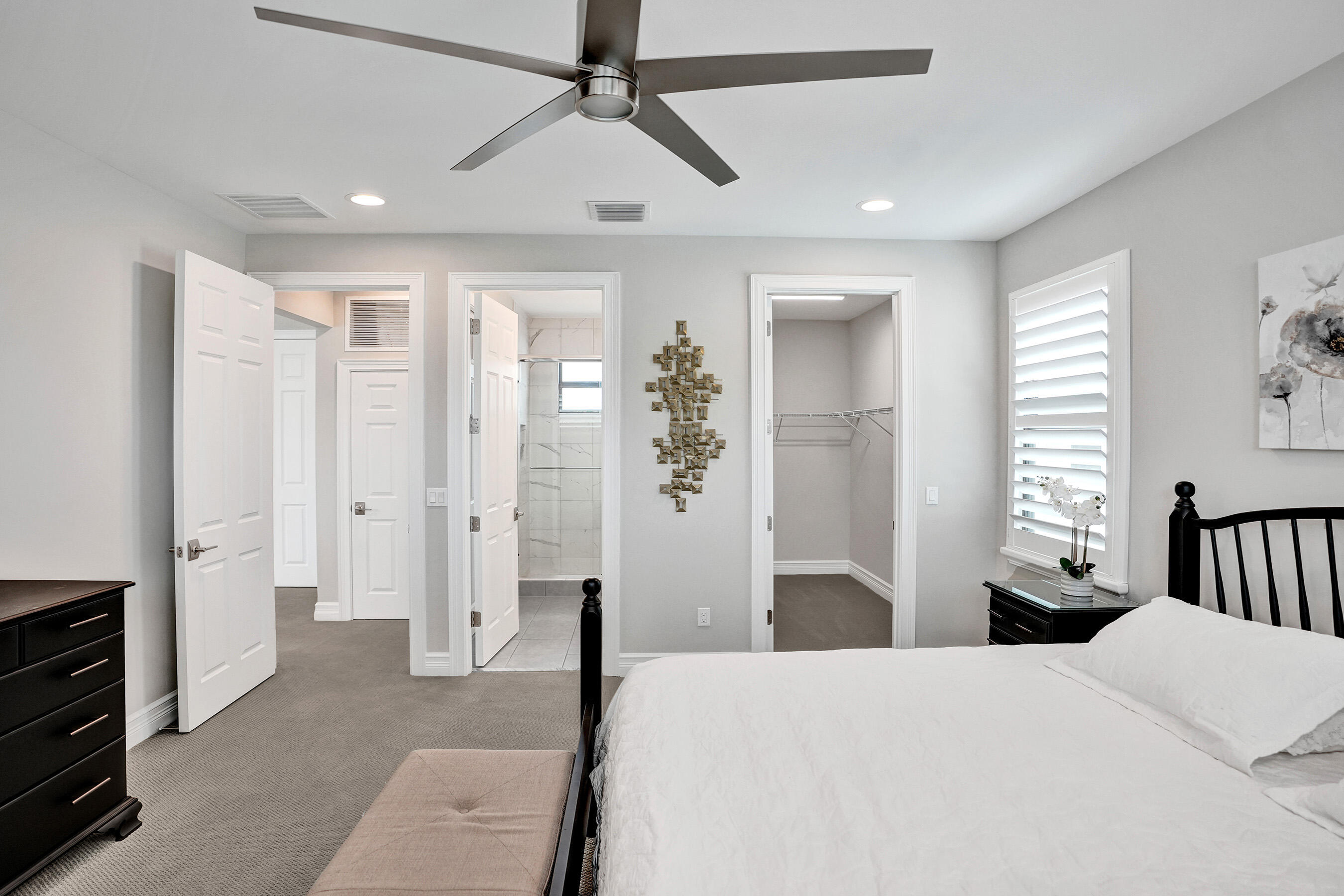 9052 Chauvet Way Boca Raton, FL 33496 - Photo 36 of 59 a bedroom with a bed and a chandelier