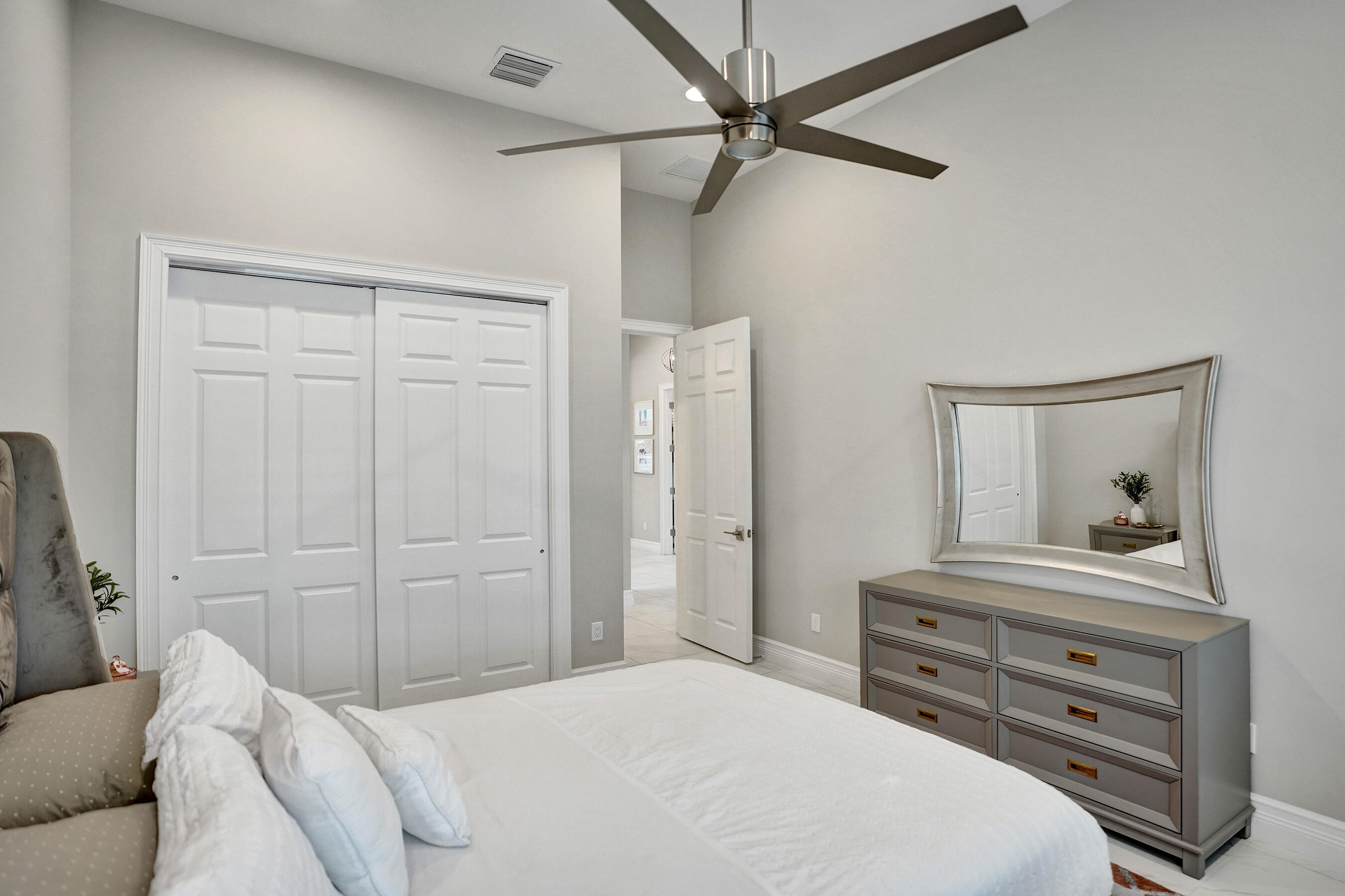 9052 Chauvet Way Boca Raton, FL 33496 - Photo 45 of 59 a bedroom with a bed and a dresser