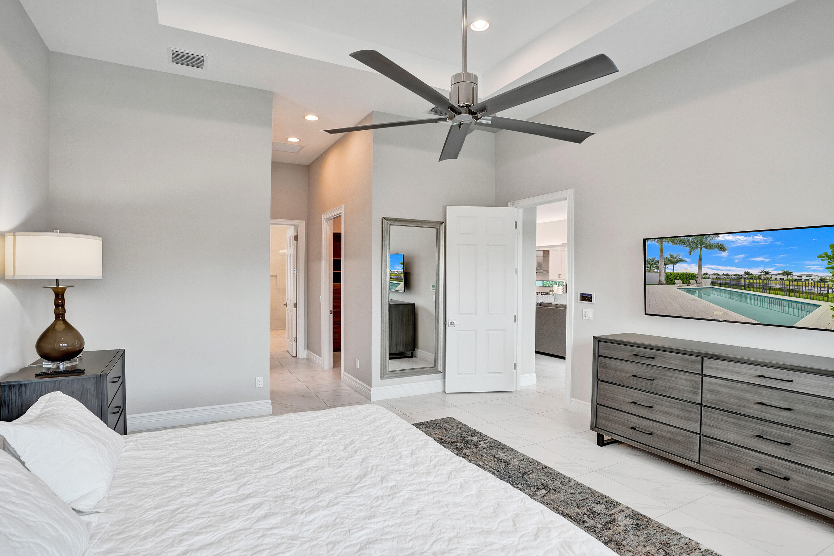 9052 Chauvet Way Boca Raton, FL 33496 - Photo 47 of 59 a bedroom with a bed and a chandelier