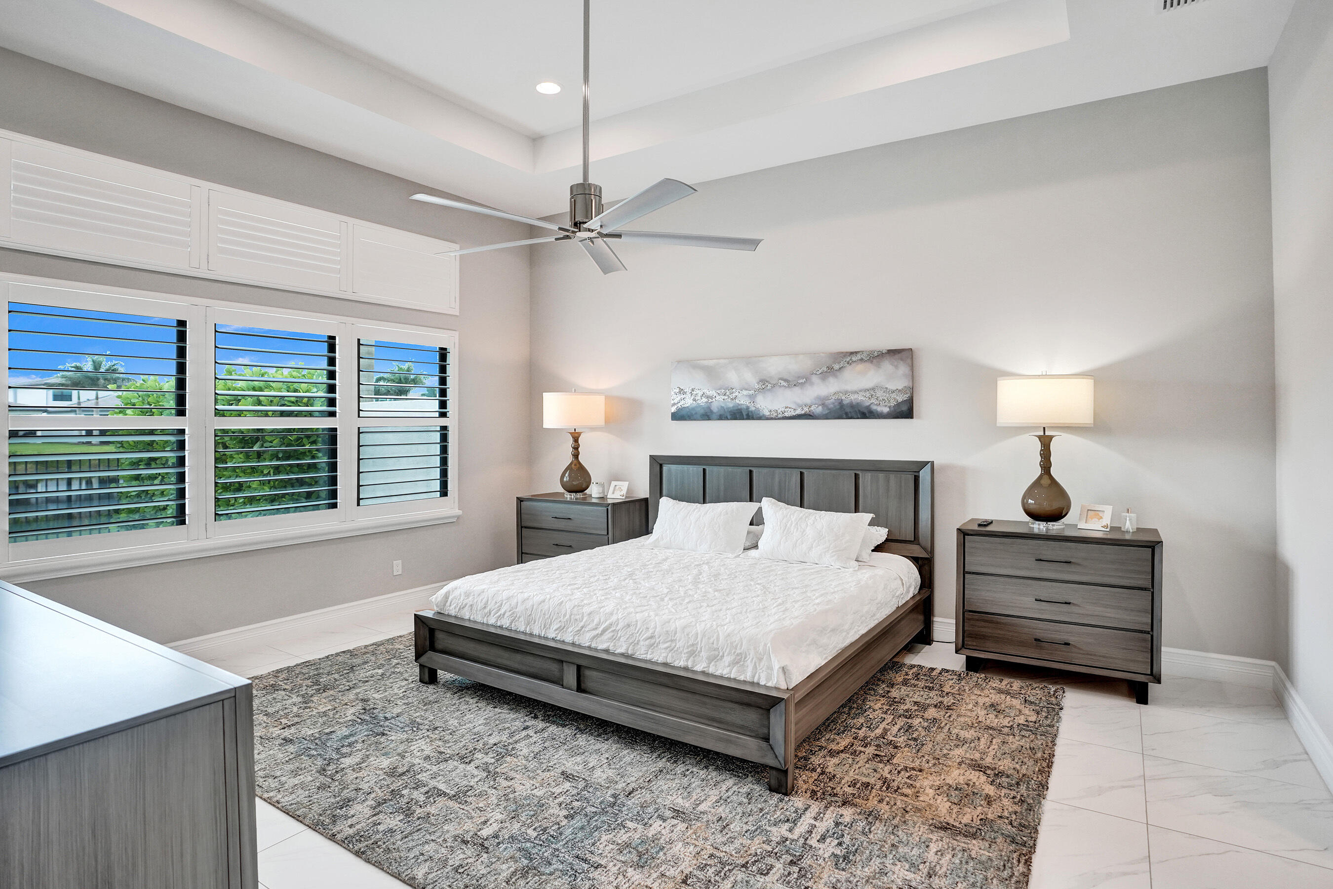 9052 Chauvet Way Boca Raton, FL 33496 - Photo 48 of 59 a bedroom with a large bed and a chandelier