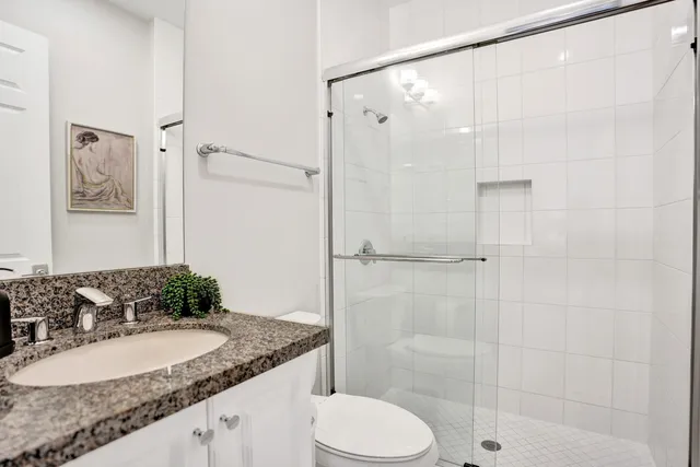 an aerial view of residential houses with outdoor space and parking