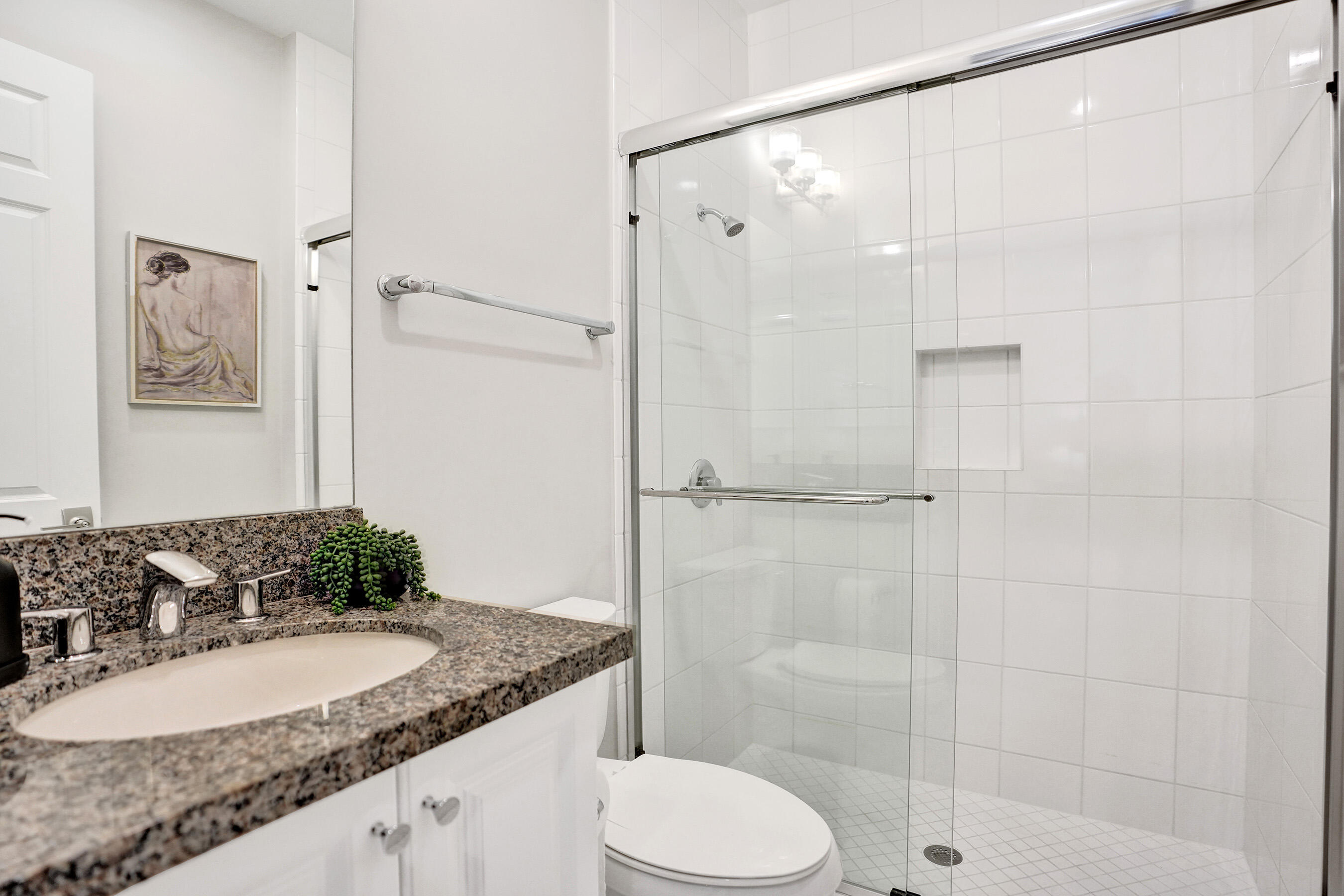 9052 Chauvet Way Boca Raton, FL 33496 - Photo 50 of 59 a bathroom with a granite countertop sink mirror toilet and bathtub