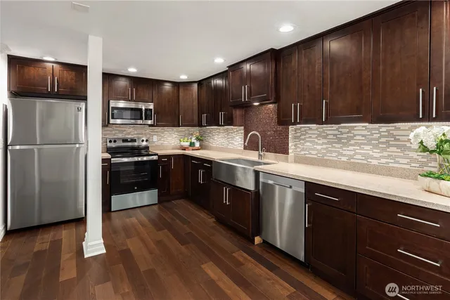 a kitchen with stainless steel appliances wooden cabinets and sink