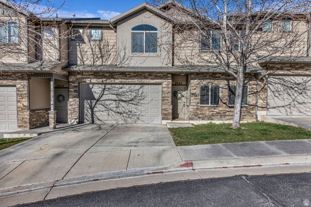2931 North 1175th Street West Layton, UT 84041 - Photo 1 of 1 Traditional home with stone siding, concrete driveway, and an attached garage