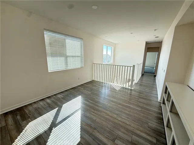 a view of a room with wooden floor