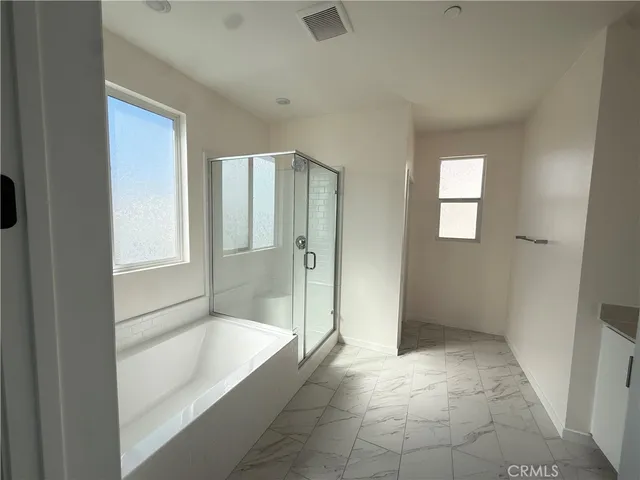 a bathroom with a granite countertop toilet a sink and a mirror