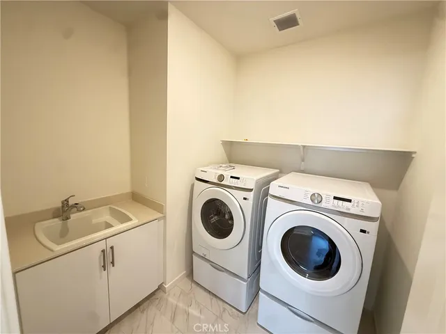 a bathroom with a sink toilet double vanity and shower