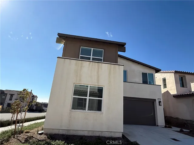 a view of backyard with outdoor seating and flowers
