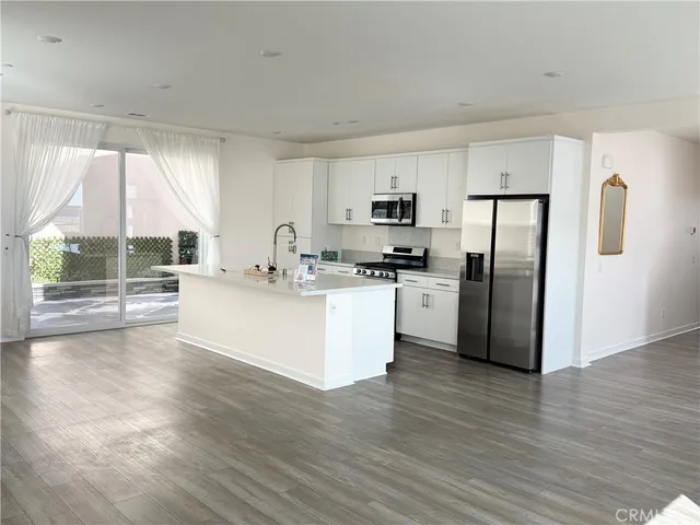 a kitchen with stainless steel appliances a refrigerator sink and cabinets
