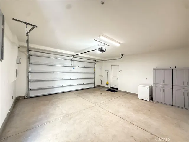 a view of a garage room and a ceiling fan