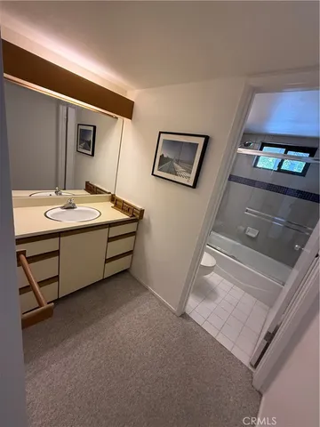 a view of a livingroom with wooden floor and staircase