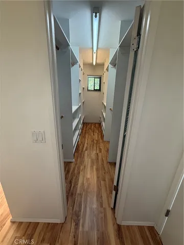 a view of a hallway with a kitchen